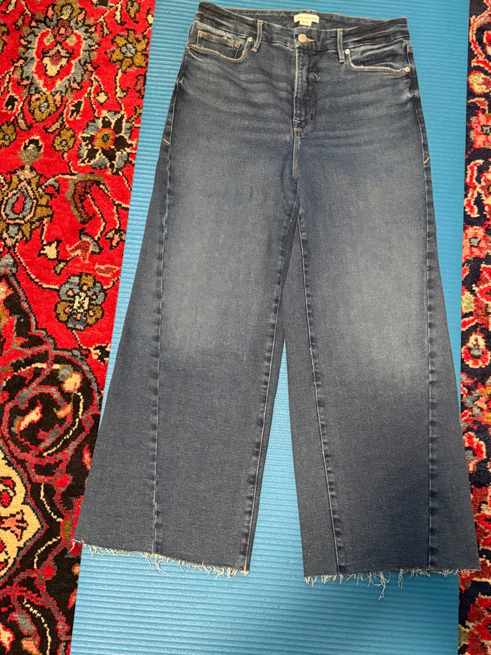 Good American Women’s Flare Twisted Raw Hem Jeans in Dark Blue Denim